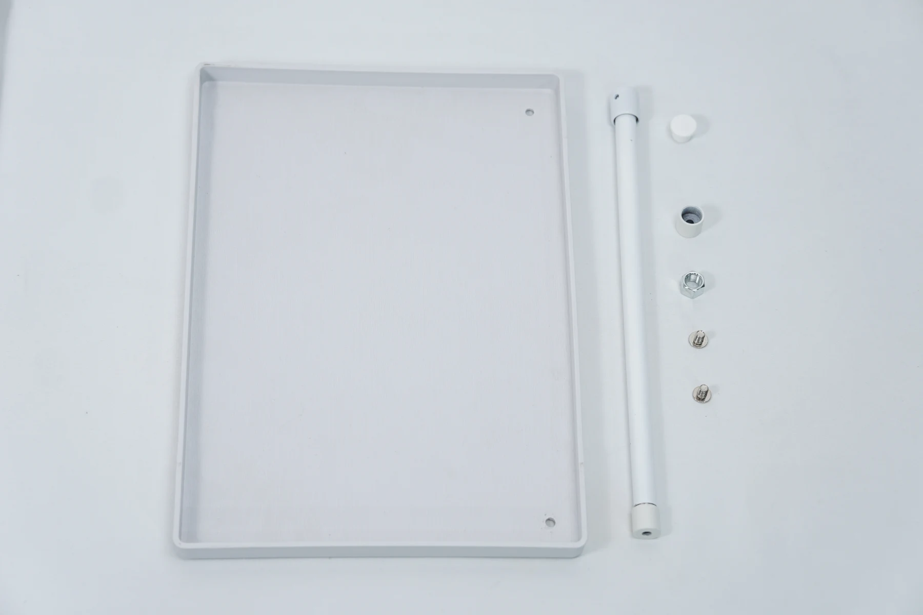 CPAP hose holder tray, support tube and smaller components laid out before assembly.