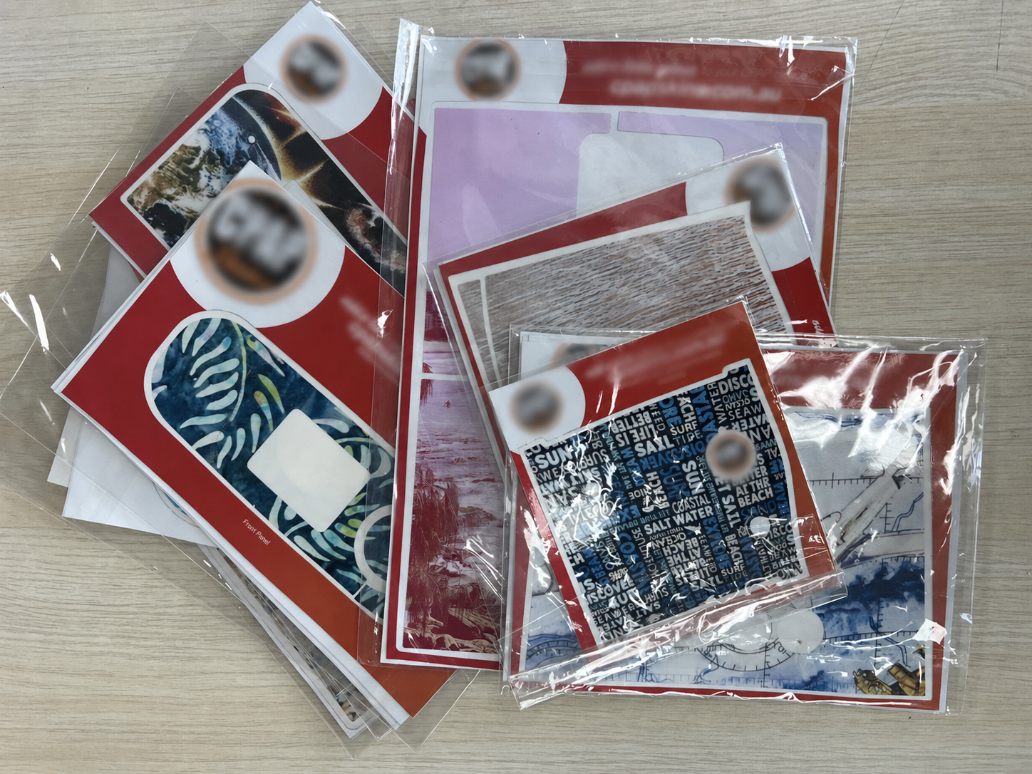 Our photograph of packaged CPAP skin samples purchased from Australia, laid out on a wooden table, with brand marks blurred.